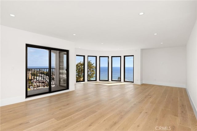 unfurnished room with recessed lighting and light wood-style flooring