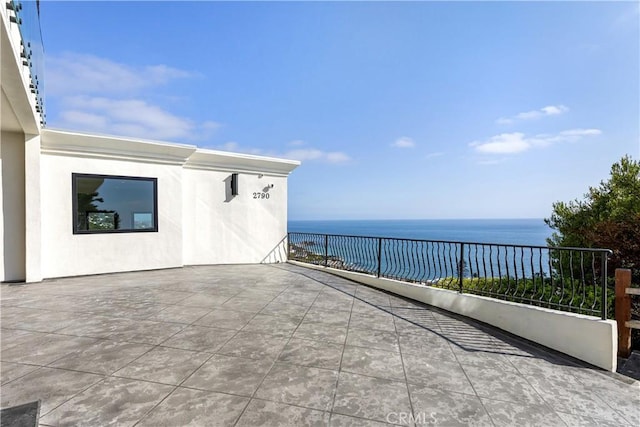 view of patio with a water view