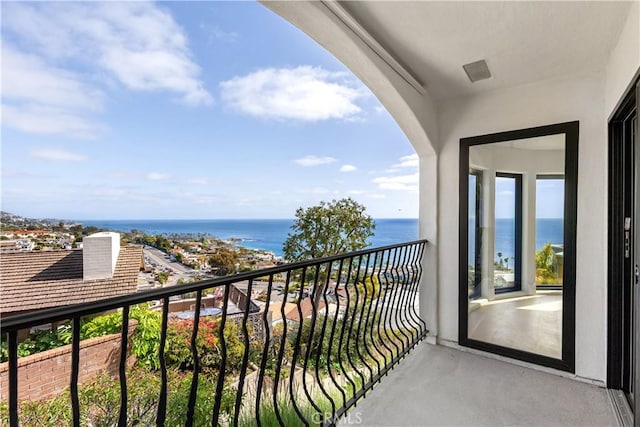 balcony with visible vents and a water view