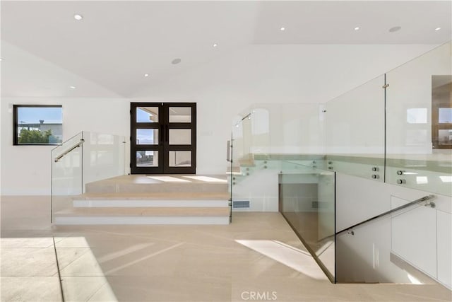 entryway with visible vents, tile patterned flooring, french doors, and lofted ceiling
