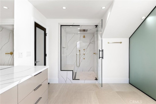 full bath featuring recessed lighting, a marble finish shower, vanity, and baseboards