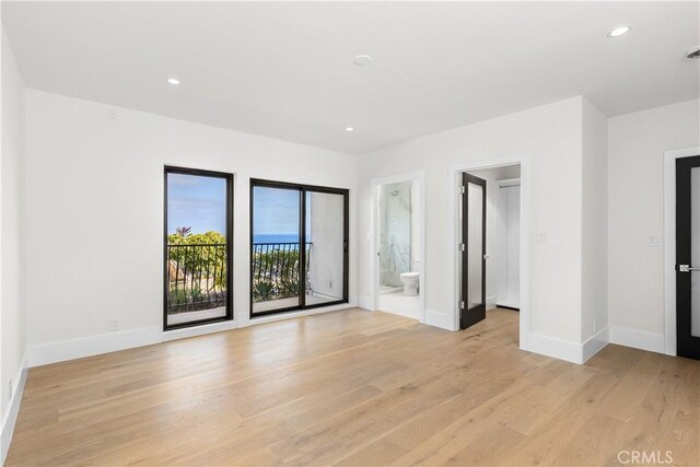 unfurnished room with recessed lighting, light wood-style floors, and baseboards