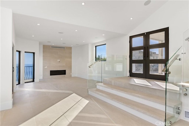 tiled foyer featuring a fireplace, french doors, recessed lighting, and visible vents