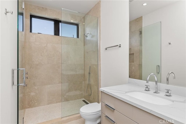 full bath with toilet, recessed lighting, tiled shower, and vanity