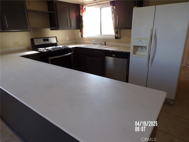 74813 Sunrise Dr Unit 29, Palms, CA 92277 - kitchen featuring stainless steel appliances, a sink, open shelves, light countertops, and light tile patterned floors