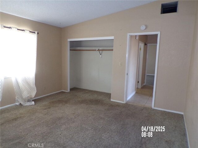 74813 Sunrise Dr Unit 29, Palms, CA 92277 - unfurnished bedroom with carpet floors, a closet, lofted ceiling, and baseboards