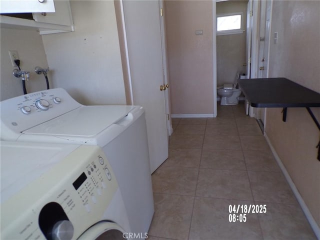 74813 Sunrise Dr Unit 29, Palms, CA 92277 - washroom with washer and clothes dryer, light tile patterned flooring, and baseboards