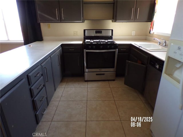 74813 Sunrise Dr Unit 29, Palms, CA 92277 - kitchen with stainless steel gas range oven, a sink, light tile patterned flooring, and light countertops
