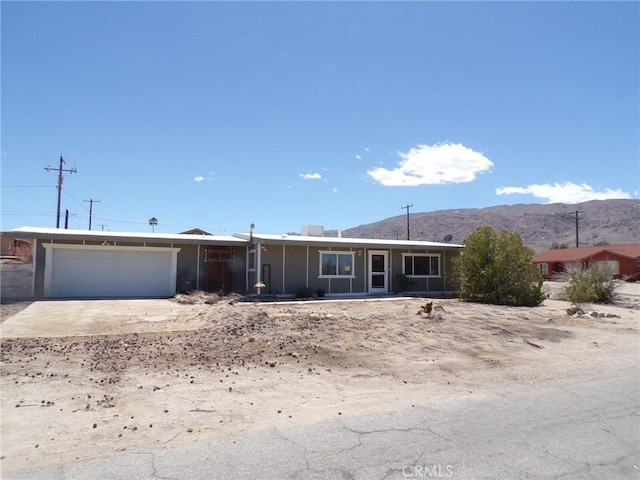 74813 Sunrise Dr Unit 29, Palms, CA 92277 - single story home featuring a garage, a mountain view, and concrete driveway