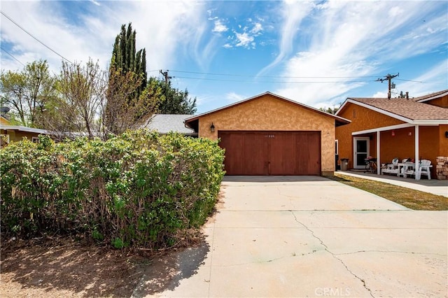 14306 Boxtree St, Lake Hughes, CA 93532 - ranch-style home with an attached garage, stucco siding, and driveway
