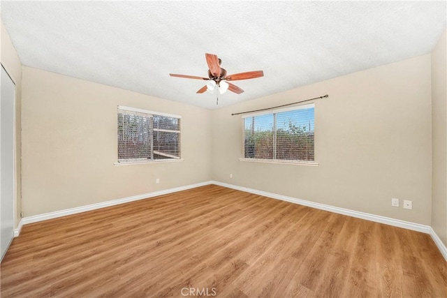 14306 Boxtree St, Lake Hughes, CA 93532 - unfurnished room featuring ceiling fan, baseboards, a textured ceiling, and light wood finished floors