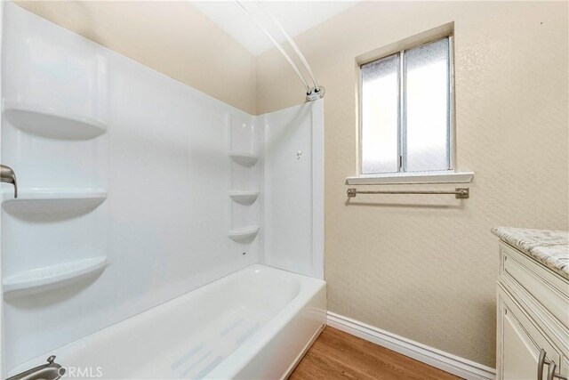 14306 Boxtree St, Lake Hughes, CA 93532 - full bath with wood finished floors, vanity, baseboards, and shower / bathtub combination