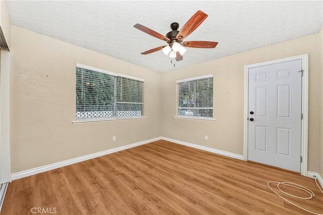 14306 Boxtree St, Lake Hughes, CA 93532 - empty room with baseboards, a ceiling fan, wood finished floors, and a textured ceiling