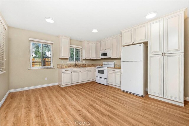 14306 Boxtree St, Lake Hughes, CA 93532 - kitchen featuring light wood-type flooring, baseboards, white appliances, and a sink