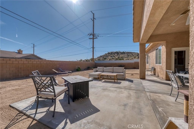 7625 Pinon Dr, Yucca Valley, CA 92284 - fenced backyard with outdoor lounge area and a patio area