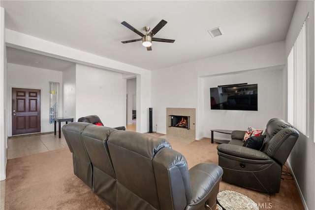 7625 Pinon Dr, Yucca Valley, CA 92284 - living area with light colored carpet, ceiling fan, and a tile fireplace