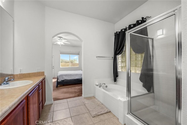 7625 Pinon Dr, Yucca Valley, CA 92284 - full bathroom featuring vanity, a shower stall, a garden tub, tile patterned flooring, and ensuite bath