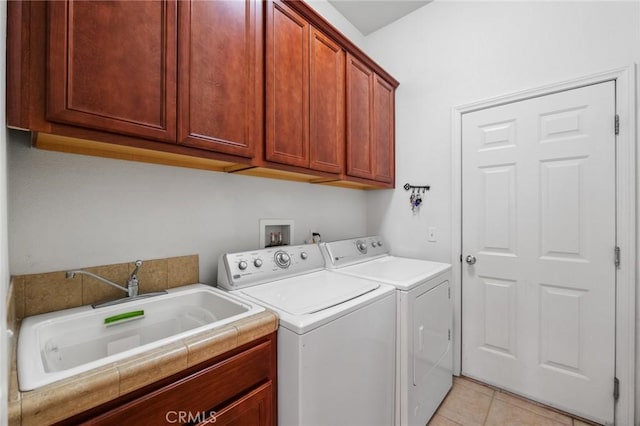 7625 Pinon Dr, Yucca Valley, CA 92284 - laundry area with cabinet space, washer and clothes dryer, and light tile patterned floors