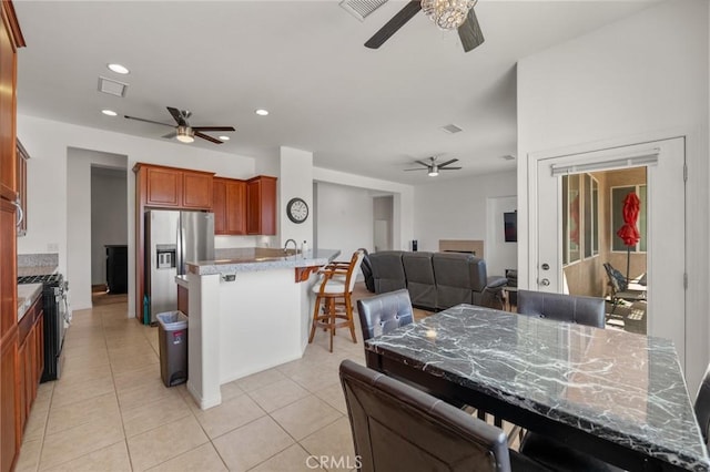 7625 Pinon Dr, Yucca Valley, CA 92284 - kitchen with ceiling fan, appliances with stainless steel finishes, a peninsula, and recessed lighting