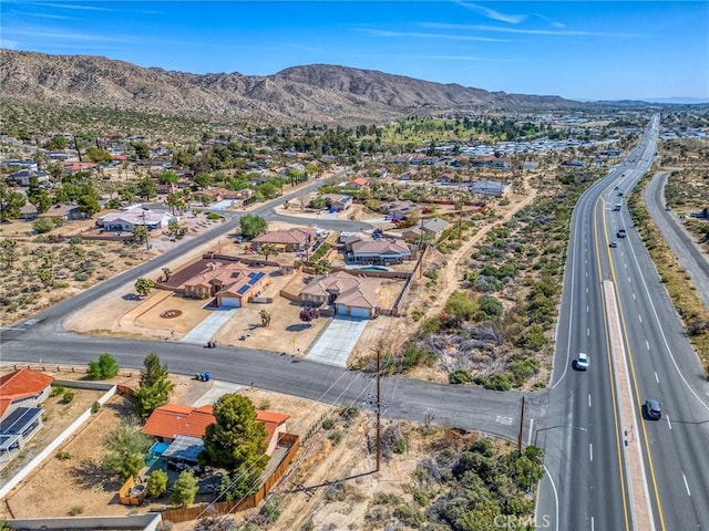 7625 Pinon Dr, Yucca Valley, CA 92284 - aerial view of residential area with a mountainous background and a major roadway