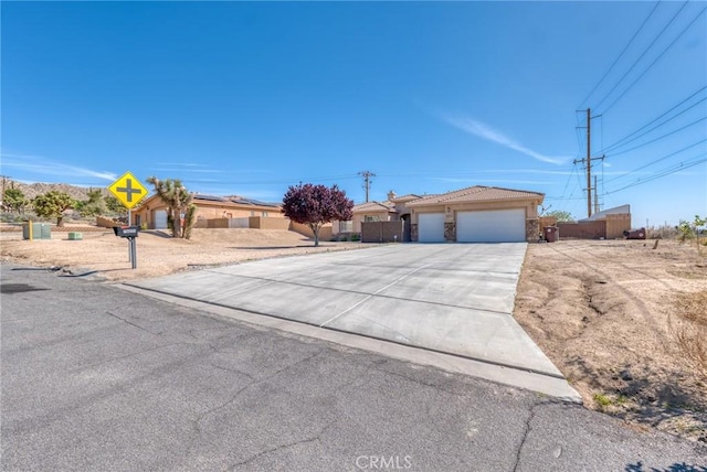 7625 Pinon Dr, Yucca Valley, CA 92284 - ranch-style house with concrete driveway and an attached garage