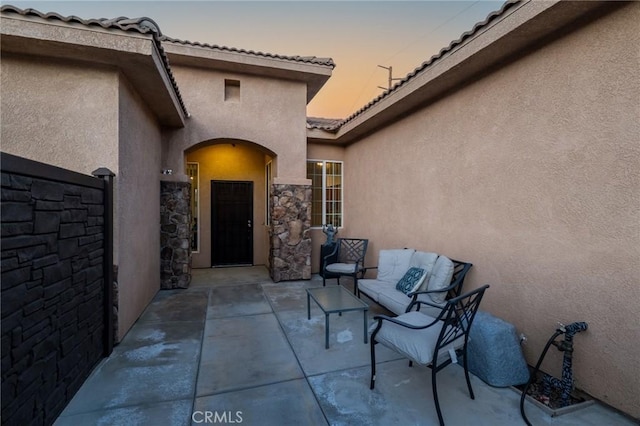 7625 Pinon Dr, Yucca Valley, CA 92284 - doorway to property featuring stucco siding, a patio area, and a tile roof