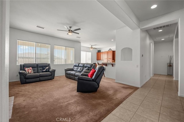7625 Pinon Dr, Yucca Valley, CA 92284 - living room featuring healthy amount of natural light, light colored carpet, a ceiling fan, light tile patterned flooring, and recessed lighting
