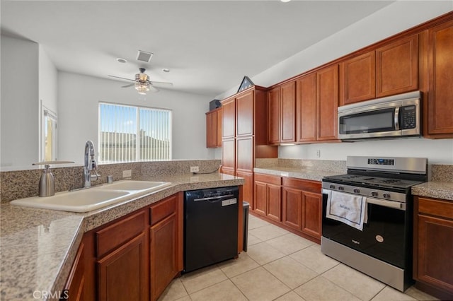 7625 Pinon Dr, Yucca Valley, CA 92284 - kitchen featuring appliances with stainless steel finishes, a ceiling fan, light tile patterned flooring, and brown cabinetry