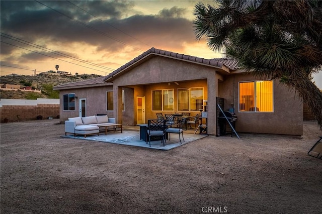 7625 Pinon Dr, Yucca Valley, CA 92284 - rear view of house featuring outdoor lounge area, stucco siding, a patio area, and a tiled roof