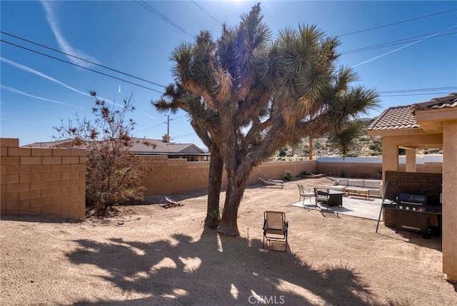 7625 Pinon Dr, Yucca Valley, CA 92284 - fenced backyard with outdoor lounge area and a patio