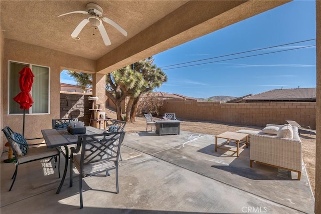 7625 Pinon Dr, Yucca Valley, CA 92284 - fenced backyard with outdoor dining space, a patio area, and a ceiling fan