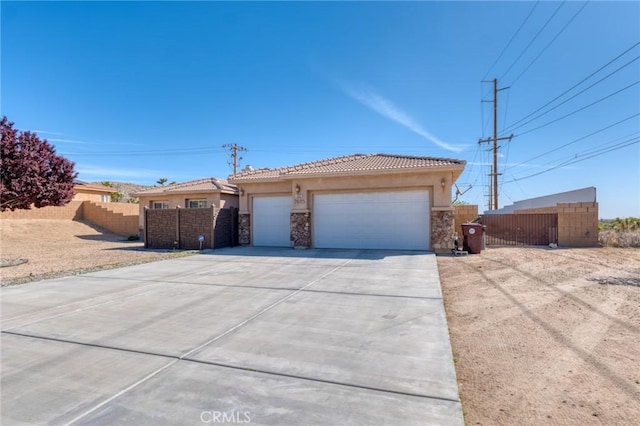 7625 Pinon Dr, Yucca Valley, CA 92284 - ranch-style house with stone siding, stucco siding, a garage, concrete driveway, and a tiled roof