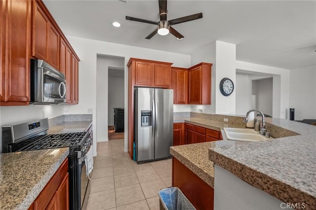 7625 Pinon Dr, Yucca Valley, CA 92284 - kitchen with appliances with stainless steel finishes, ceiling fan, light tile patterned floors, recessed lighting, and a peninsula