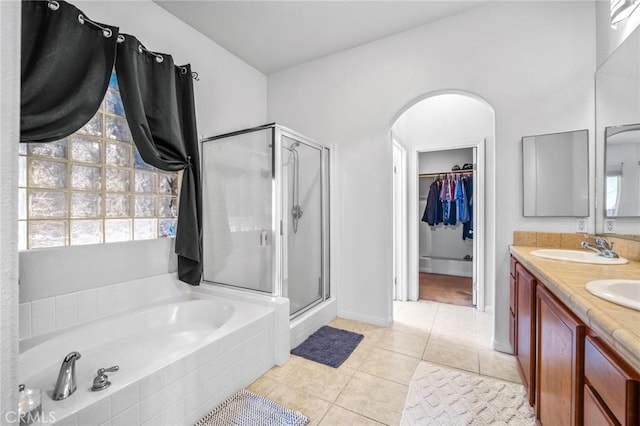 7625 Pinon Dr, Yucca Valley, CA 92284 - bathroom featuring a stall shower, a spacious closet, a bath, double vanity, and tile patterned floors