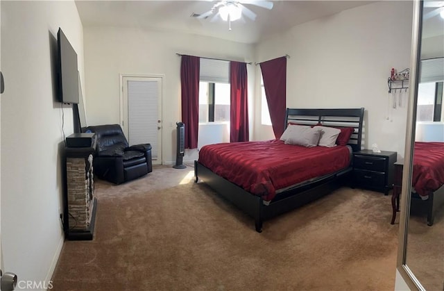 7625 Pinon Dr, Yucca Valley, CA 92284 - carpeted bedroom featuring multiple windows and ceiling fan