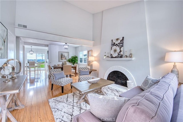 22911 Via Santiago, Mission Viejo, CA 92691 - living room with a high ceiling, visible vents, wood finished floors, and a fireplace