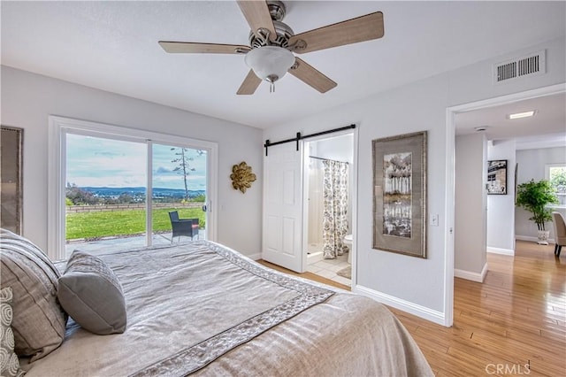 22911 Via Santiago, Mission Viejo, CA 92691 - bedroom featuring visible vents, light wood-style floors, a barn door, access to exterior, and baseboards