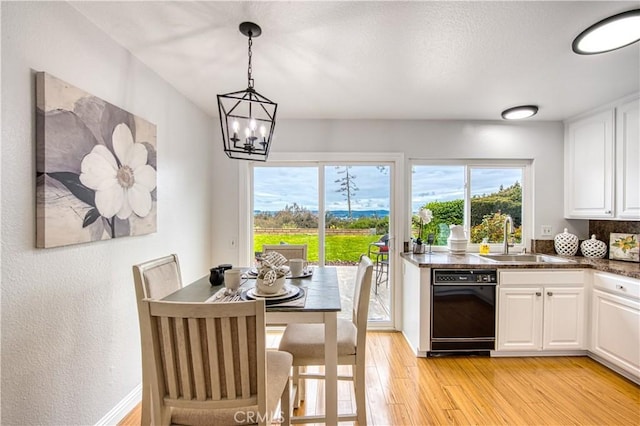 22911 Via Santiago, Mission Viejo, CA 92691 - kitchen featuring dishwasher, a sink, white cabinetry, and light wood-style floors