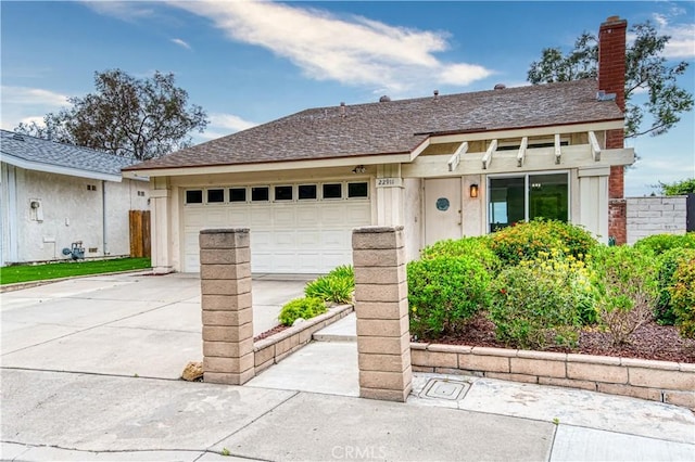 22911 Via Santiago, Mission Viejo, CA 92691 - view of front facade featuring driveway, a chimney, and an attached garage