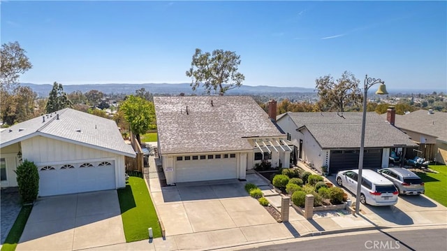 22911 Via Santiago, Mission Viejo, CA 92691 - view of front of home with concrete driveway, a shingled roof, board and batten siding, and a mountain view