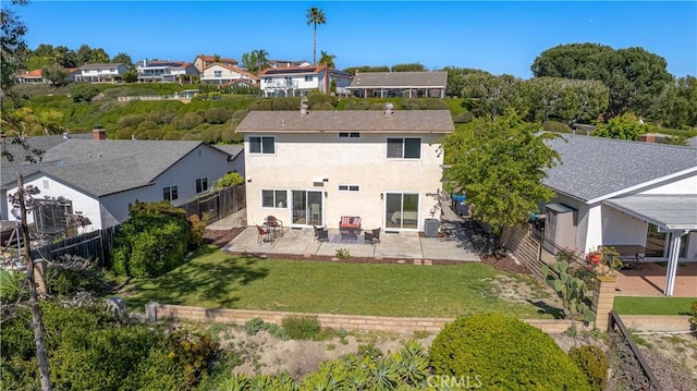 22911 Via Santiago, Mission Viejo, CA 92691 - rear view of house with a fenced backyard, stucco siding, a yard, a patio, and a residential view