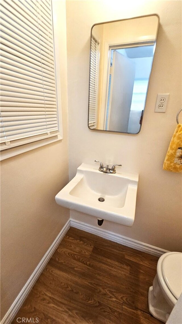 1060 Newhill St, Glendora, CA 91741 - bathroom featuring baseboards, wood finished floors, toilet, and a sink