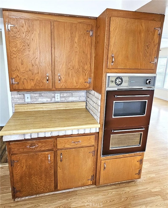 1060 Newhill St, Glendora, CA 91741 - kitchen featuring brown cabinetry, light wood-style flooring, and double wall oven