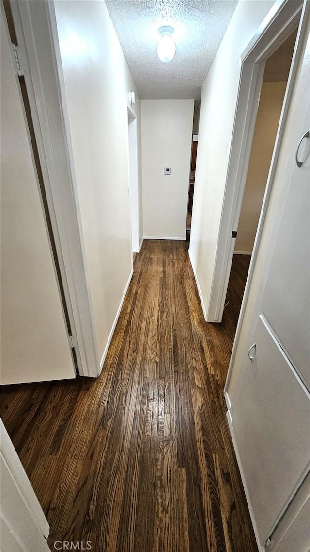 1060 Newhill St, Glendora, CA 91741 - corridor with dark wood-style floors, a textured ceiling, and baseboards