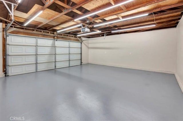 garage with a garage door opener and baseboards