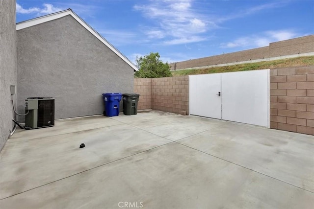view of patio / terrace with central air condition unit and a fenced backyard