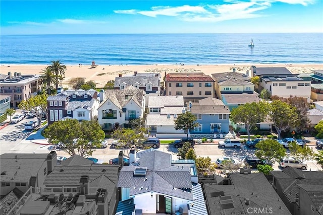 bird's eye view with a view of the beach, a water view, and a residential view
