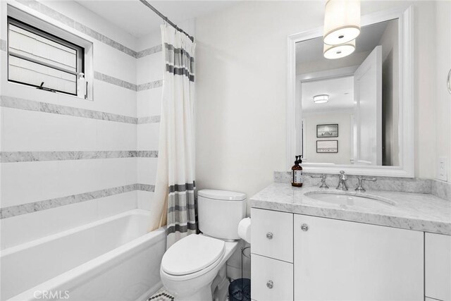 full bathroom featuring shower / bath combo, toilet, and vanity