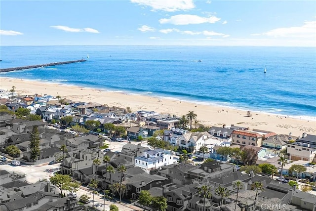 drone / aerial view featuring a beach view and a water view