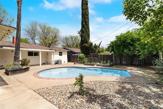 view of pool featuring a fenced backyard, a fenced in pool, and a patio